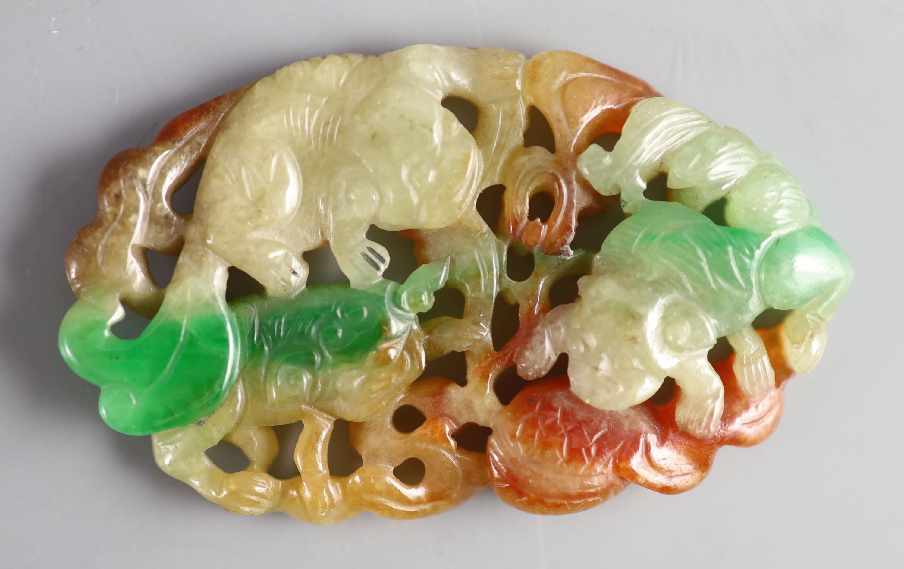 A Chinese three colour jadeite pendant plaque, 19th/20th century, 6.5cm